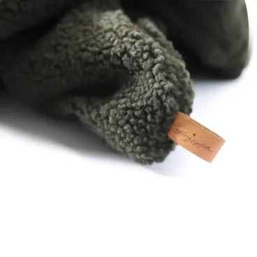 Détail de la finition du tissu et de la marque en cuir  de la gigoteuse Cocoon pour chien